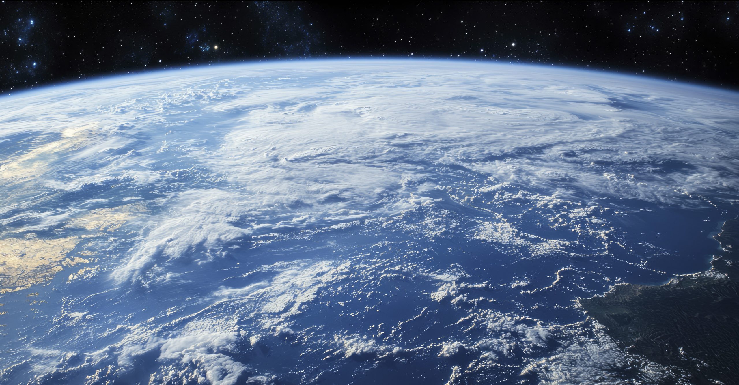 Earth's Surface with White Clouds and a Starry Night Sky